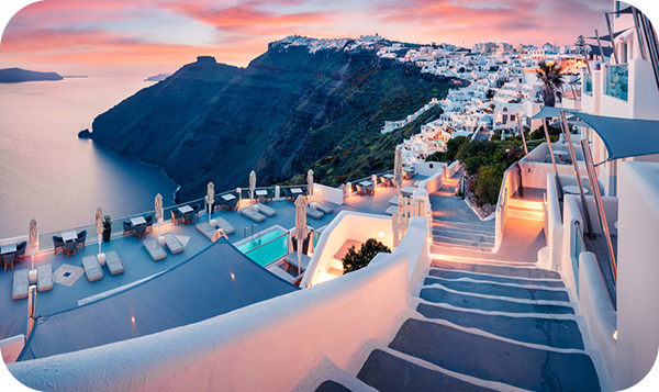 White-washed buildings with blue domes overlooking Aegean Sea, Santorini, Greece